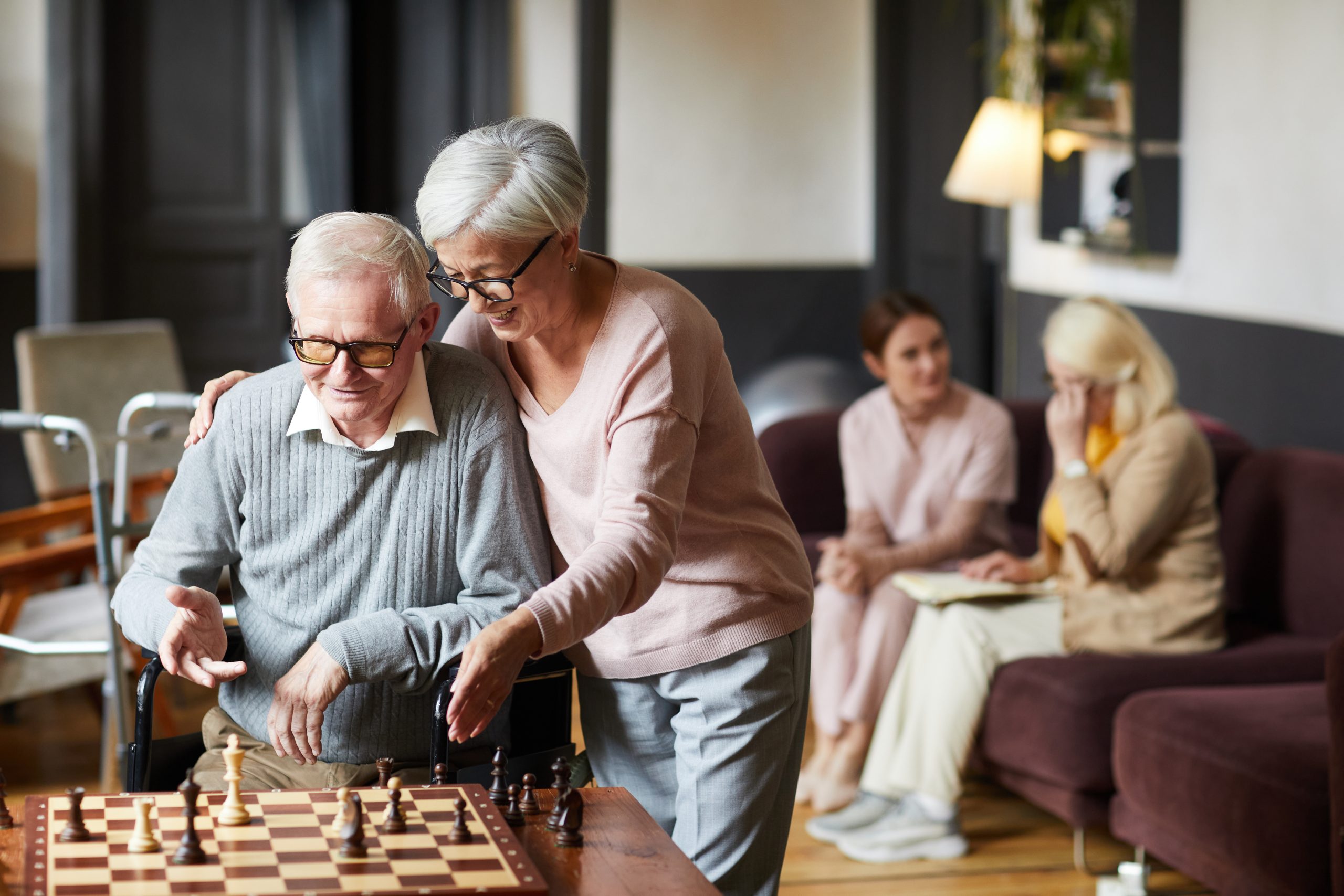 seniors staying active during the winter by playing chess in a nursing home